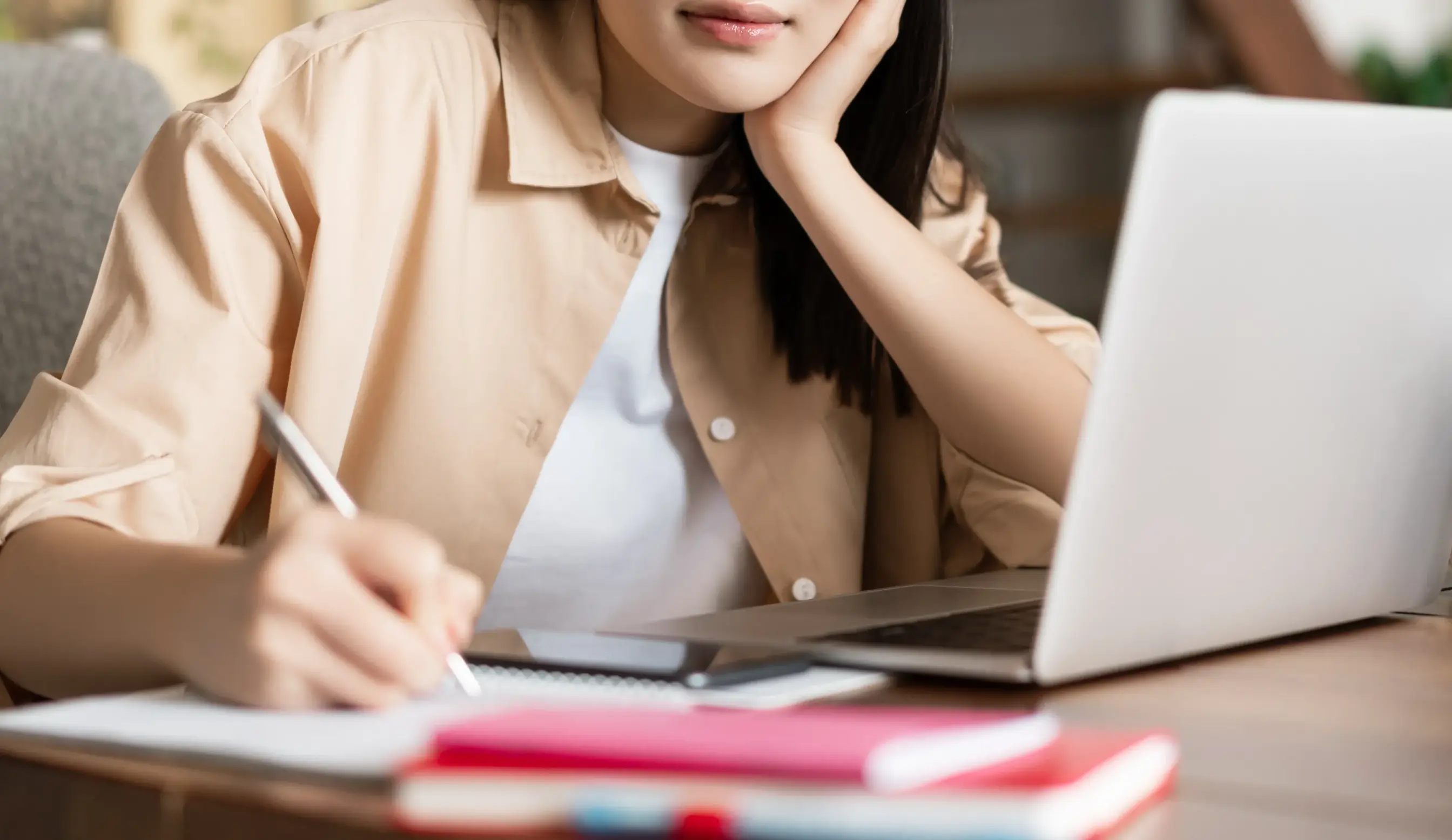 Young Asian Girl Taking Notes Writing Doing Homework Sitting Near Laptop Korean Woman Working Fr Scaled