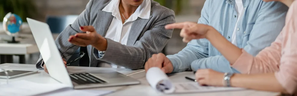Black Female Insurance Agent Using Computer With Couple During Consultations Office