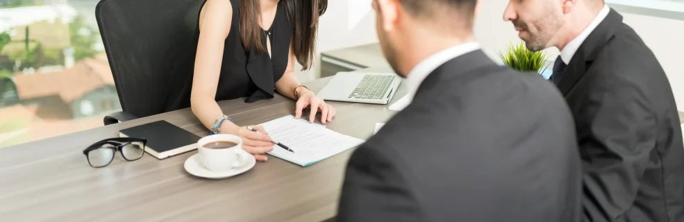Female Real Estate Agent Explaining Rental Agreement Businessmen Office